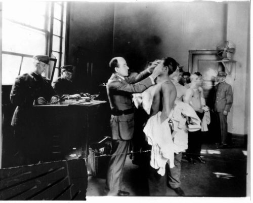 Ellis Island medical check. Image courtesy of Wikimedia Commons.